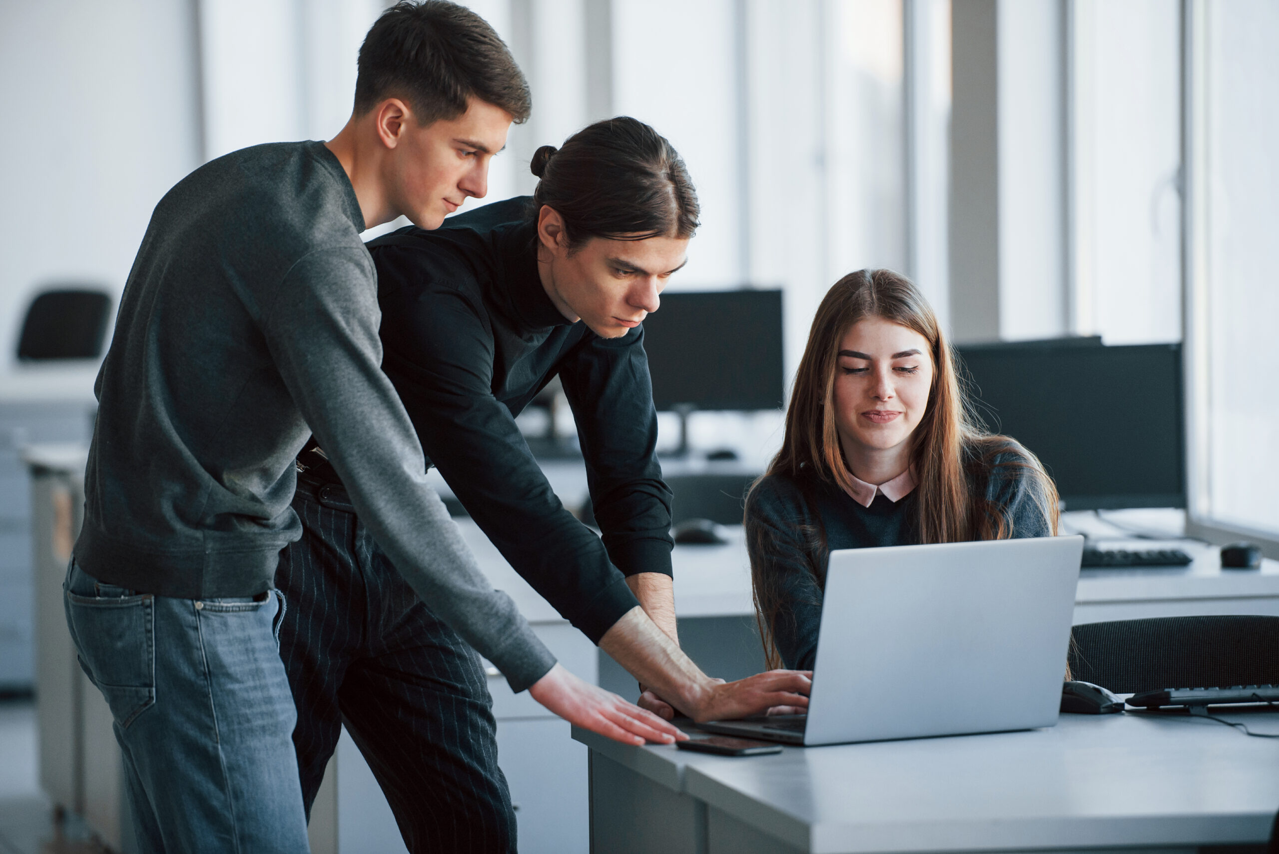 Results will be worth it. Group of young people in casual clothes working in the modern office.